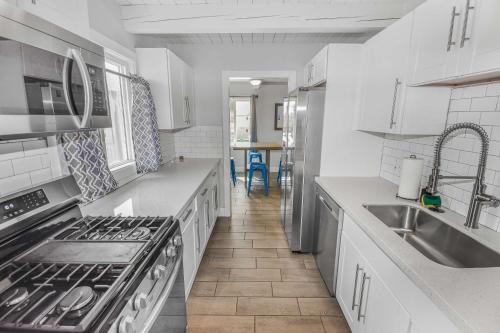 a kitchen with a sink and a stove top oven at Premier Stay Near Casinos with King Beds & Entertainment in Reno