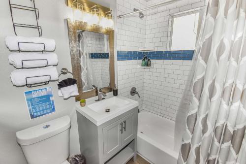 a bathroom with a sink and a toilet and a shower at Premier Stay Near Casinos with King Beds & Entertainment in Reno