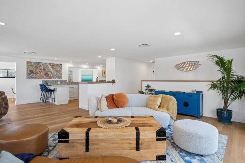 a living room with a couch and a table at Gawura in Burrill Lake