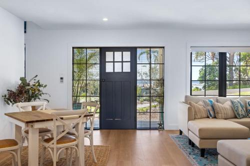 a living room with a table and a couch at Gawura in Burrill Lake