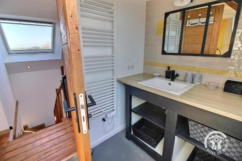 a bathroom with a sink and a mirror at La marie morgane in Lézardrieux