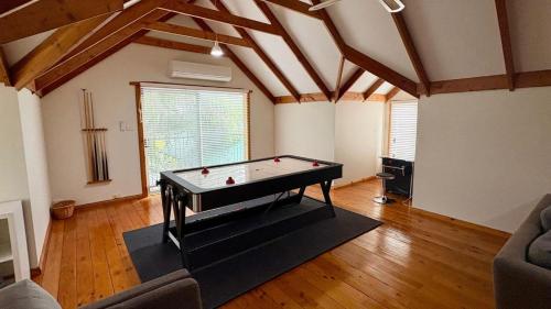 a living room with a pool table in it at Timber Tides Retreat in Geographe