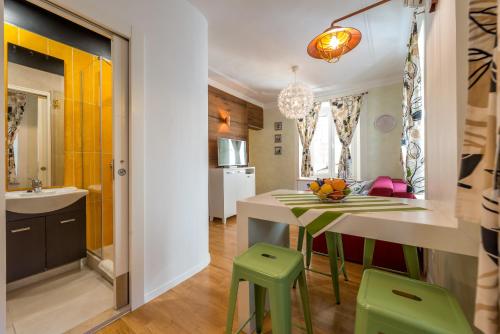 a kitchen and dining room with a table and chairs at Apartments Petra in Dubrovnik