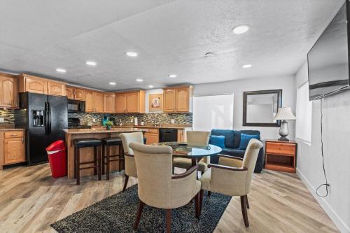 a kitchen and living room with a table and chairs at Modern Private Whole Unit 4 Bedroom Guest Suite King Bed in Salt Lake City