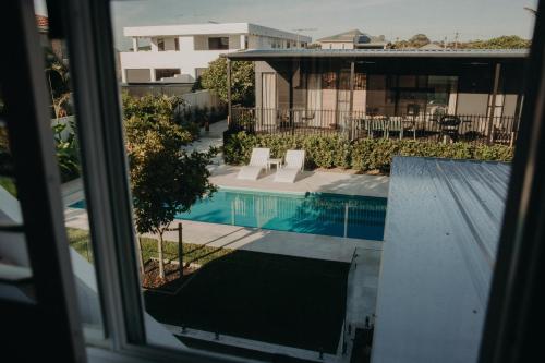 a view of a swimming pool from a window at Park St in Evans Head