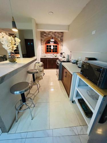 a kitchen with a counter and stools in a room at Casa Velodromo in Xalapa