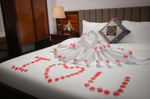a wedding dress made out of red hearts on a bed at Bamboo Sapa Hotel in Sa Pa