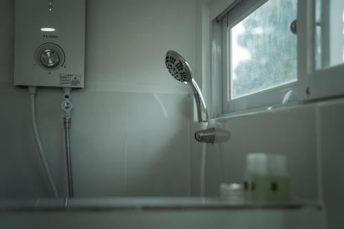 a shower in a bathroom next to a mirror at White Villa in Koh Rong
