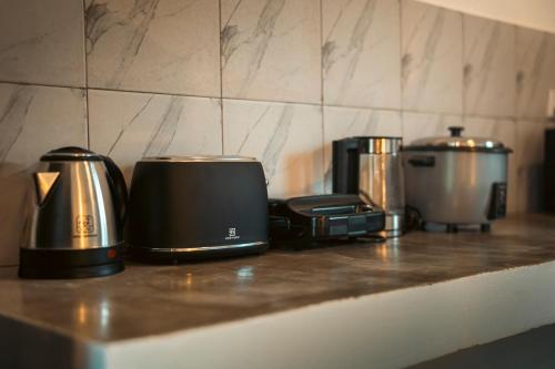 a counter top with two toasters and a toaster at White Villa in Koh Rong