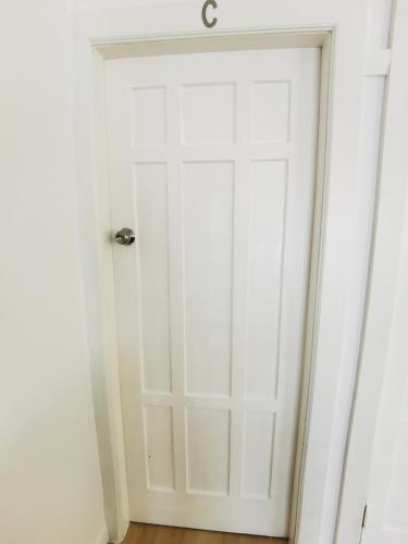 a white closet door with a silver door knob at Regent Residential House in Whangarei