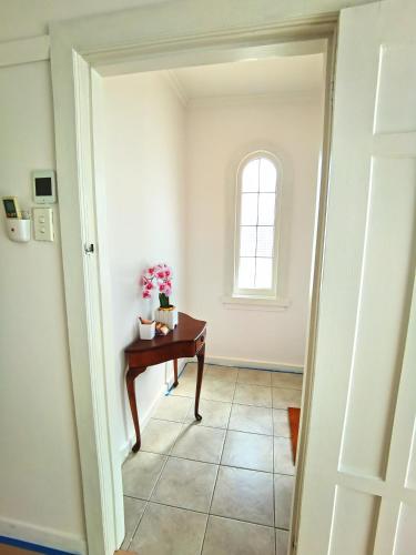 a hallway with a desk and a window at Regent Residential House in Whangarei