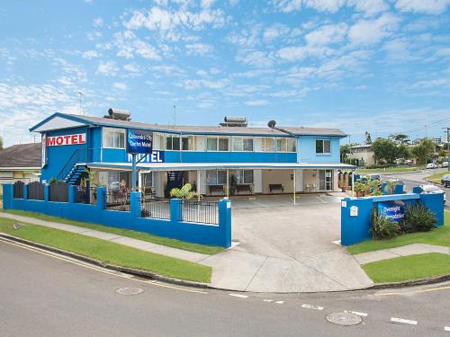 a blue and white building next to a parking lot at Caloundra City Centre Motel in Caloundra