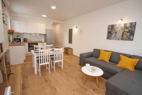a living room with a couch and a table and a kitchen at NEW Apartment Roko Zvekovica -Cavtat,near Dubrovnik airport in Cavtat