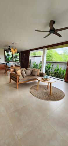 a living room with a couch and a table at Sumberkima Resort in Pemuteran