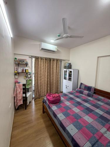a bedroom with a bed with a checkered blanket at Luxe 3bhk bungalow Baner in Pune