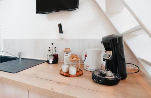 a kitchen counter with a coffee maker on a counter top at Logement en rez-de-chaussée in Aubenas