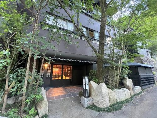 an exterior view of a house with trees at Yusai Bekkan in Minamioguni
