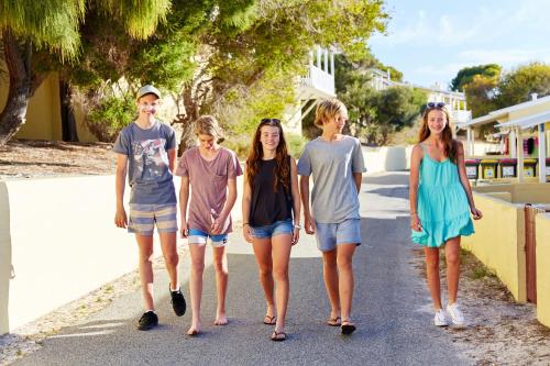 a group of young people walking down a street at Stay Rottnest in Rottnest Island