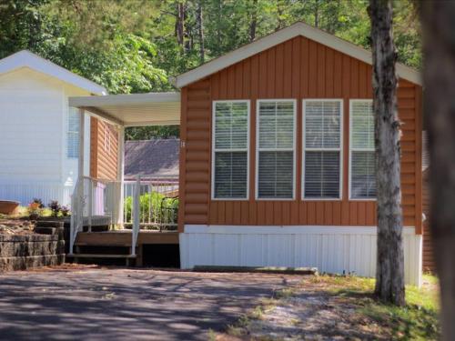 a brown house with a porch and a white house at Relaxing Model Home near Dollywood in Pigeon Forge