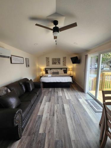 a living room with a couch and a bed at Relaxing Studio Cottage with Parking in Pigeon Forge