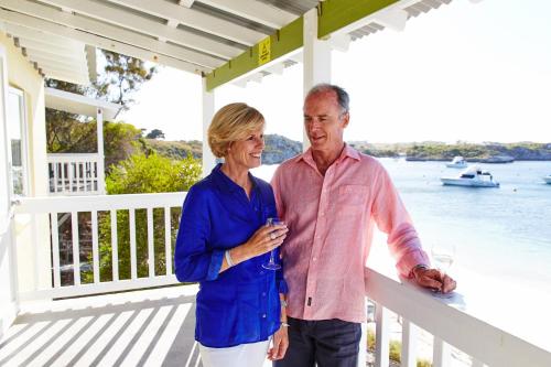 a man and woman standing on the porch of a house at Stay Rottnest in Rottnest Island