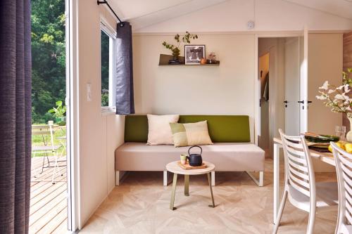 a living room with a couch and a table at Domaine MON CALME in Piriac-sur-Mer