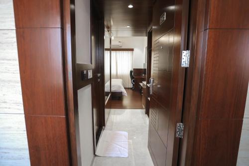 a hallway leading to a room with a bed at Hotel Lakshmi Towers in Kāngayam