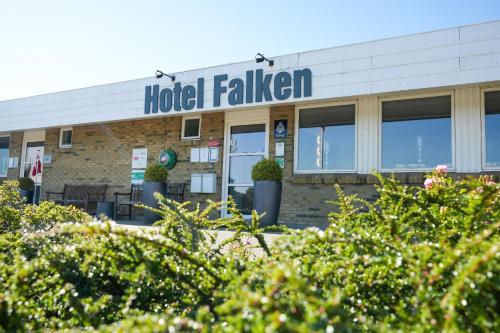 a hotel falling sign on top of a building at Hotel Falken in Videbæk