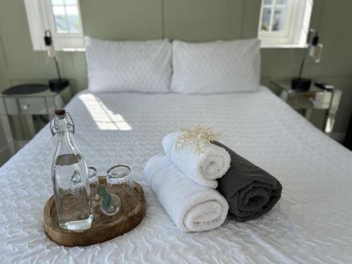 a hotel room with a bed with towels and a bottle at Luxury Cottage, views of the Lakes with Hot Tub in Cockermouth