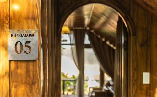 a sign on the door of a building with windows at KỲ VIÊN Home & Cafe in Xuân Thọ