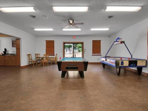 a room with two ping pong tables in it at Beautiful Model Home with Breathtaking View in Pigeon Forge