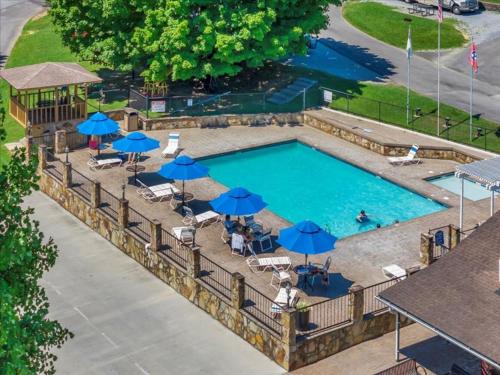 an overhead view of a swimming pool with umbrellas at Beautiful Model Home with Breathtaking View in Pigeon Forge