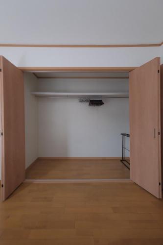 an empty room with two closet doors and a wooden floor at Villa Lotus in Kamakura