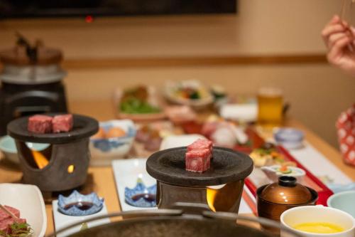 a table with food on a table with food at Dantokan Kikunoya in Otsu