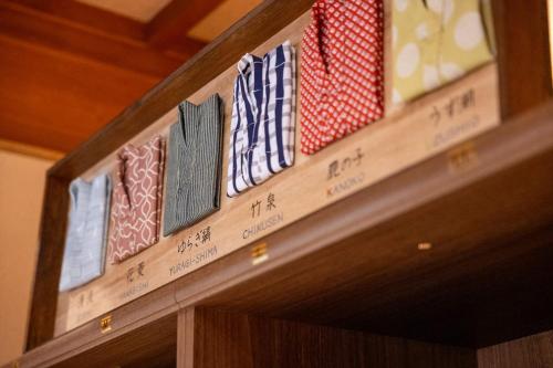 a row of ties on top of a wooden door at Dantokan Kikunoya in Otsu