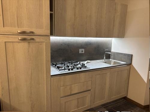 a kitchen with a stove and a sink at Torre Antica Montese appartamento 1 in Montese