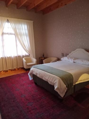 a bedroom with a large bed and a large window at Reeds House - a place to feel at home in Queenstown