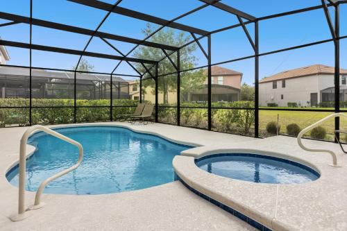 a large swimming pool with a pergola and a swimming pool at 5259-6-WW-Pool&SPA Lazy River&Slides in Davenport
