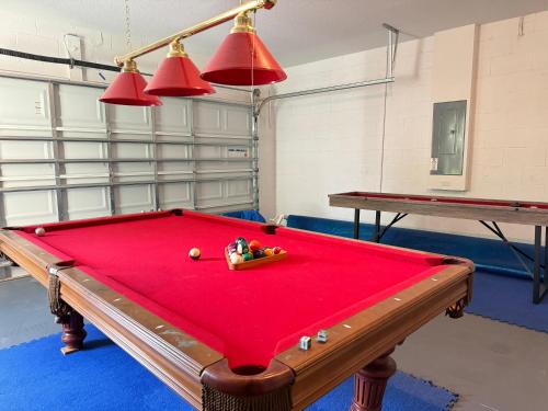a pool table in a room with two ping pong tables at 5259-6-WW-Pool&SPA Lazy River&Slides in Davenport