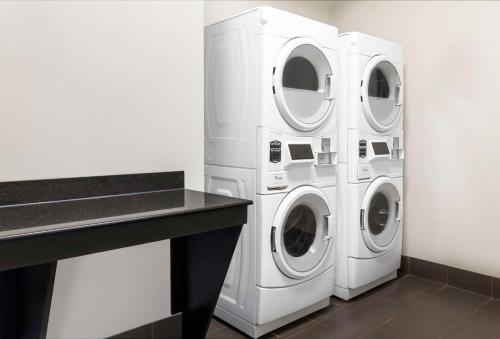 two washing machines in a laundry room with a counter at Hampton Inn Olathe in Olathe