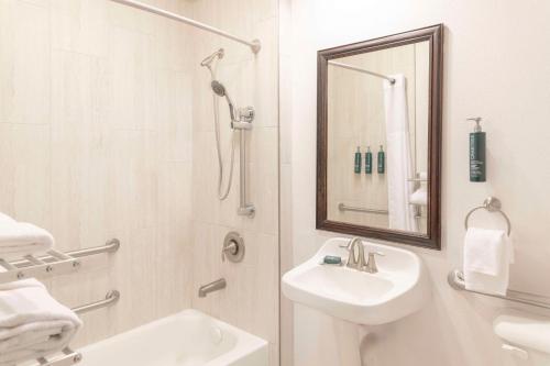 a white bathroom with a sink and a shower at DoubleTree by Hilton Phoenix-Gilbert in Gilbert