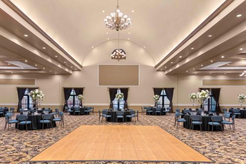 a banquet hall with tables and chairs and a projection screen at DoubleTree by Hilton Phoenix-Gilbert in Gilbert