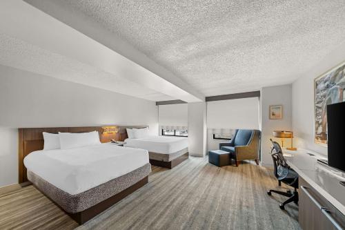 a hotel room with a bed and a desk at Hilton Garden Inn Plymouth in Plymouth