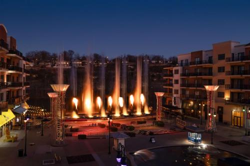 a view of a fountain in a city at night at Hilton Promenade Branson Landing in Branson