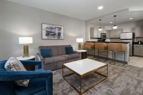 a living room with a couch and a table at Hilton Promenade Branson Landing in Branson