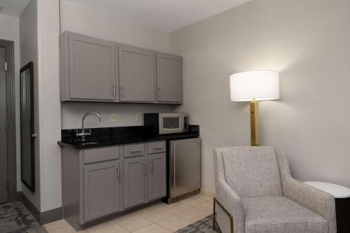 a hotel room with a chair and a microwave at Hilton Promenade Branson Landing in Branson
