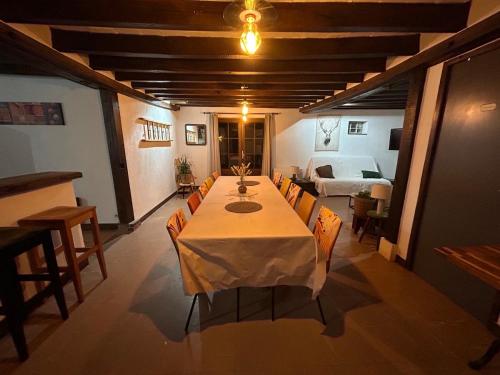 a dining room with a table and chairs and a bed at Gîte 1, ouvriers, campagne, piscine 1h de beauval in Nouan-le-Fuzelier