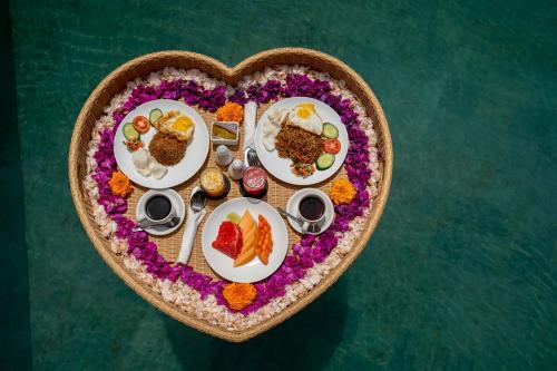 a heart shaped plate of food in the shape of a heart at The Macaw Ubud Green Uma Villa in Blahbatu