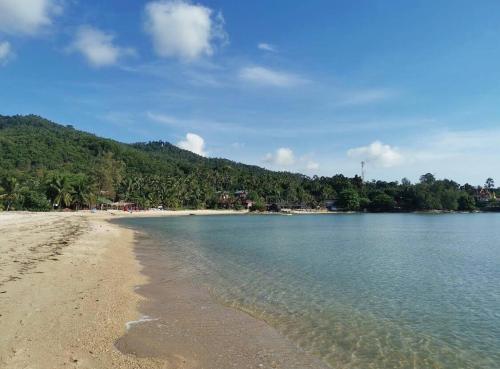 a view of a beach with trees in the background at Villa Koh Mzé, 2 bedrooms with peaceful pool in Hua Thanon Beach