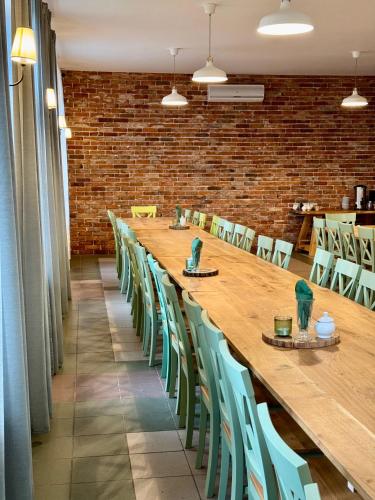 a long wooden table and chairs in a room at Domki Wierzchy in Wierzchy